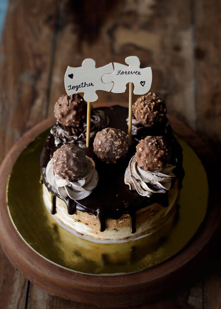 Close-up of Eggless Ferrero Rocher Cake showing its moist layers, chocolate frosting
