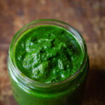 Close-up of the vibrant green mint coriander chutney kept in a jar