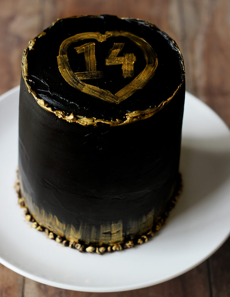 Elegant Black and Gold Cake served in a plate, ready to eat