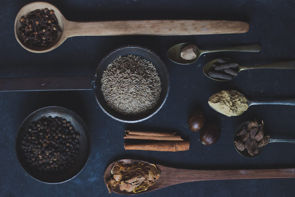 A variety of whole spices, such as cumin, coriander, and cardamom, used for making homemade garam masala