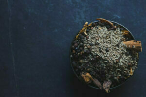 Spices being mixed together in a bowl to create a homemade garam masala blend