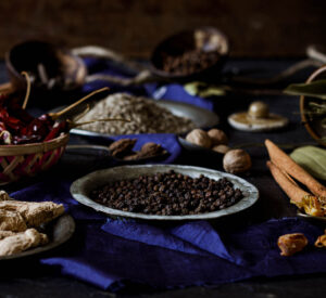 A close-up of various ground spices used in homemade garam masala