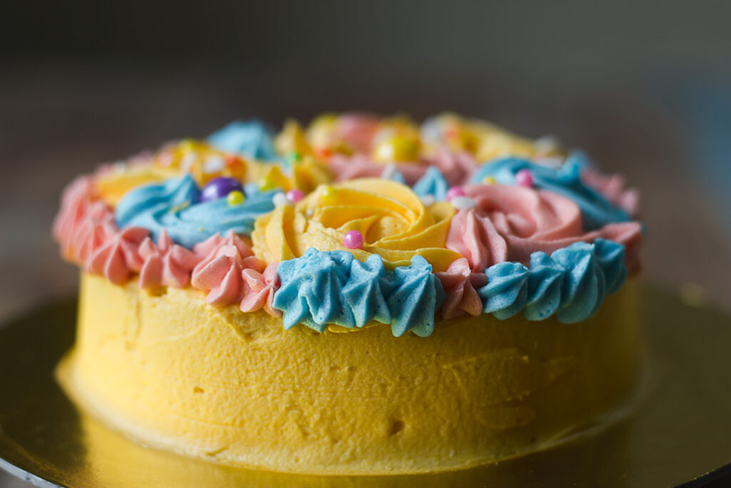 A beautifully decorated eggless buttercream garden cake with colorful floral designs