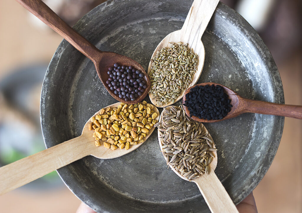 Ingredients for khatta meetha kaddu recipe, including different spices