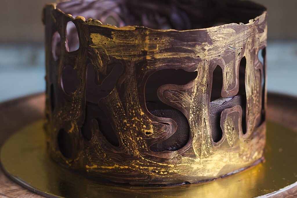 The eggless chocolate collar cake displayed on a cake stand
