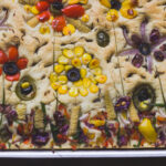 A table setting with garden focaccia as the centerpiece