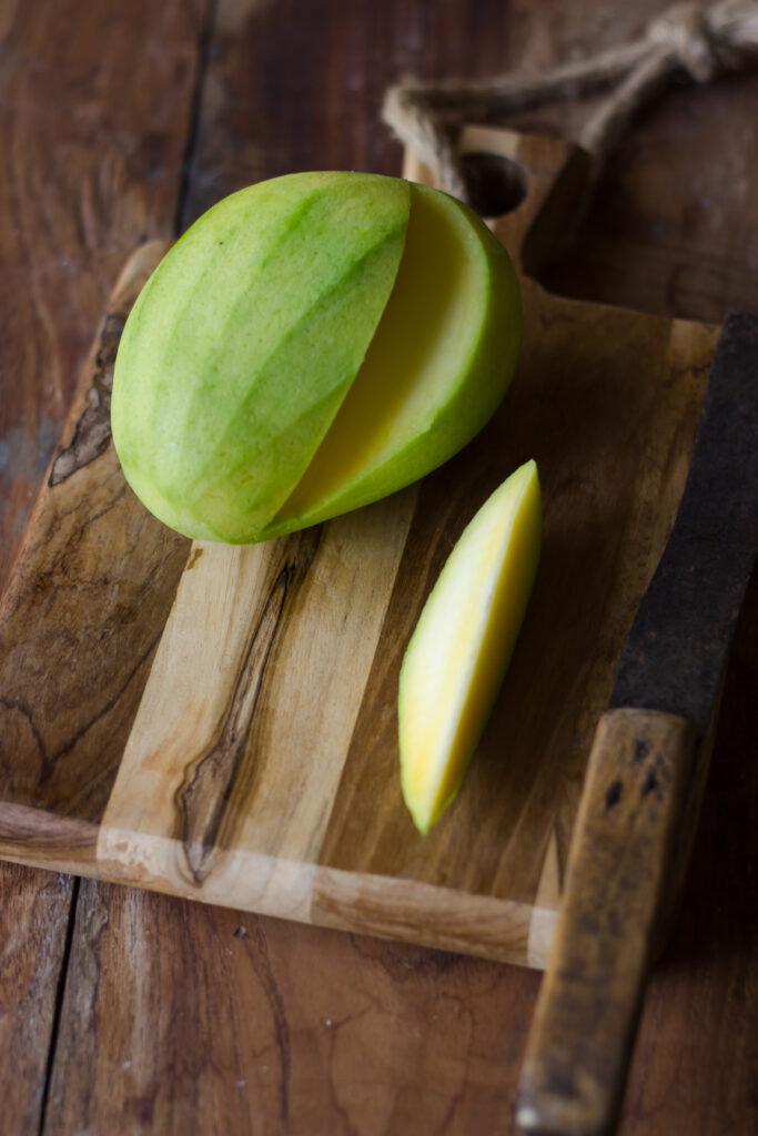 A slice of raw mango with perfect tanginess