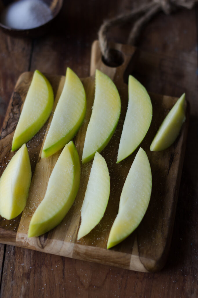 Raw mangoes cut into small pieces for pickling