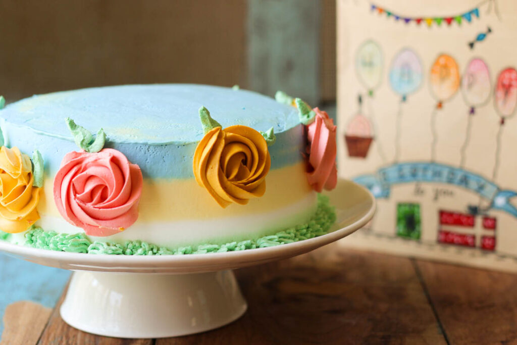 Side view of a whole eggless mango spring cake