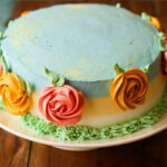 Side view of a whole eggless mango spring cake