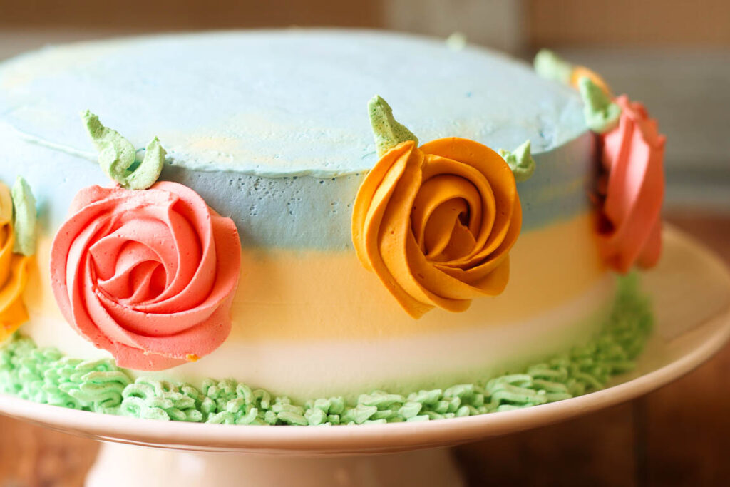 Homemade eggless mango spring cake cooling on a wire rack