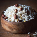 A bowl of freshly prepared Poha Chivda Namkeen garnished with curry leaves and peanuts