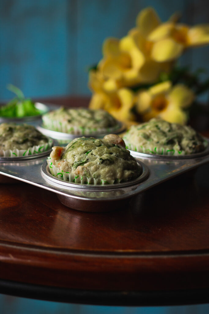 Savory spinach and cheese muffins in a muffin tray, ready to be served