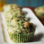 Close-up of a fluffy spinach and cheese muffin with melted cheese on top