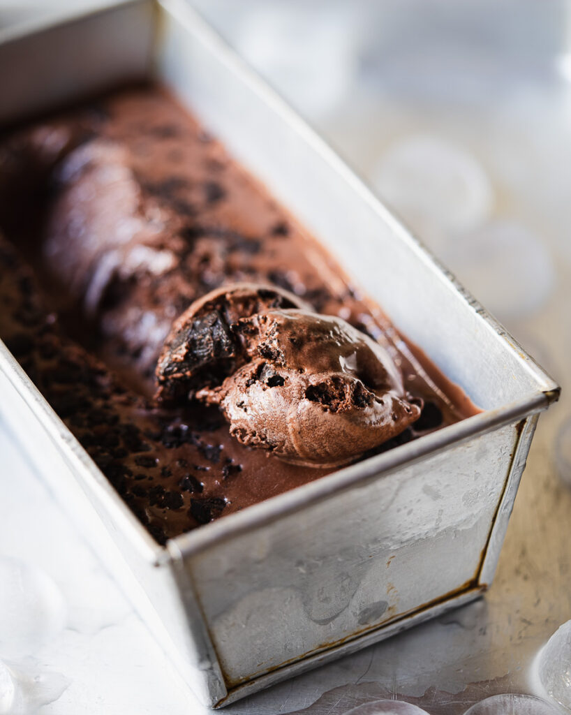 Chocolate ice cream with melted chocolate drizzle and mini chips on top