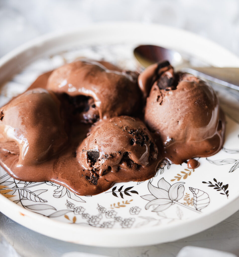 Frozen chocolate ice cream mixture being transferred to container