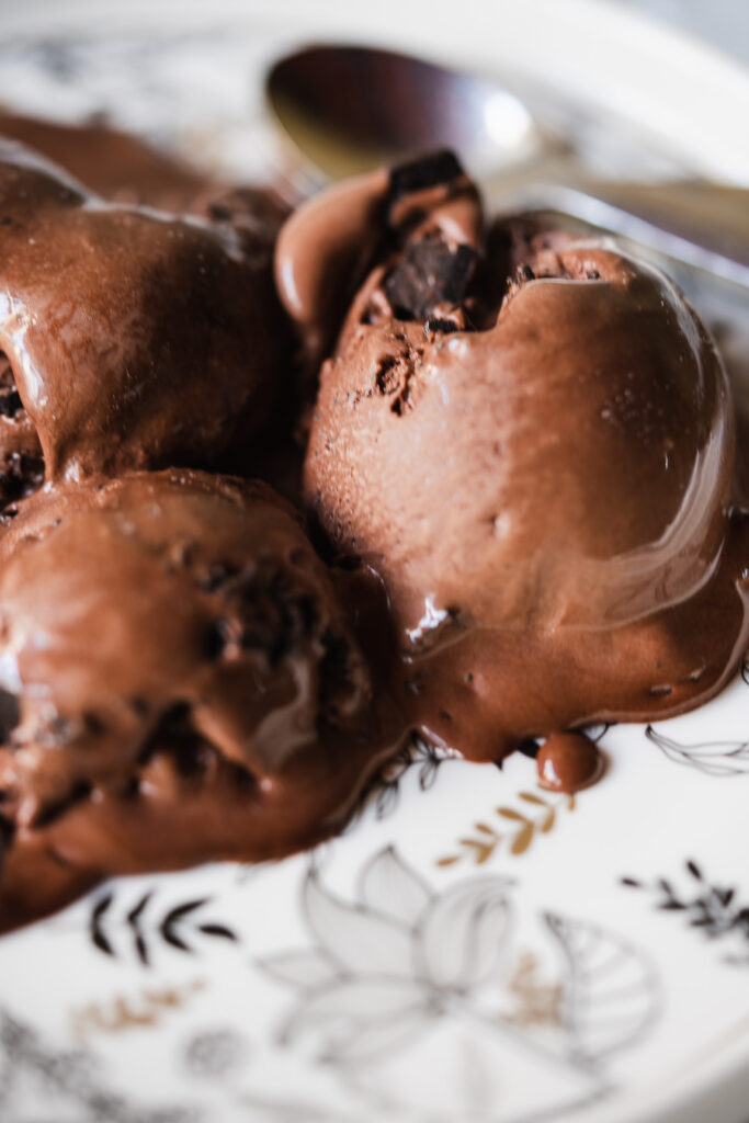 Soft chocolate chip ice cream in a rustic setting with dark background