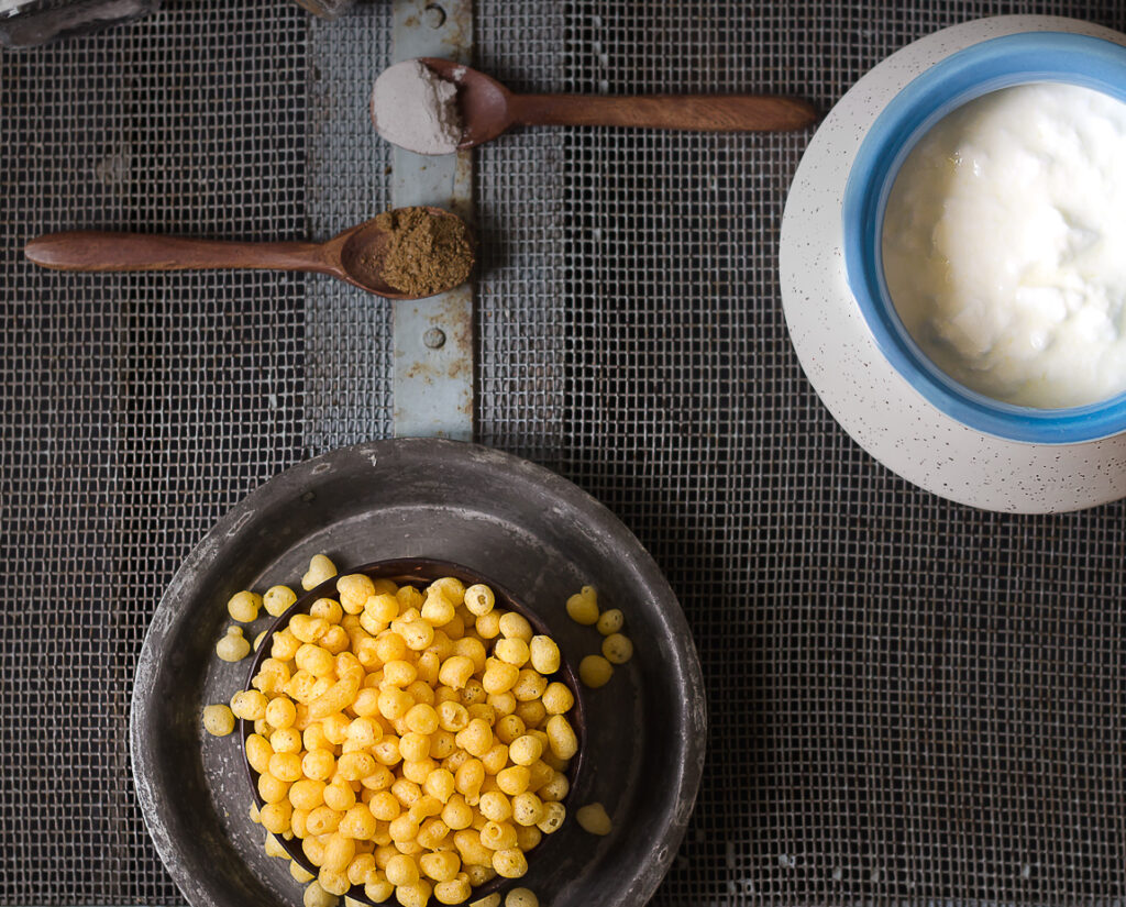 Ingredients of Boondi raita | A bowl of boondi and curd along with the spoonful of black salt and cumin powder